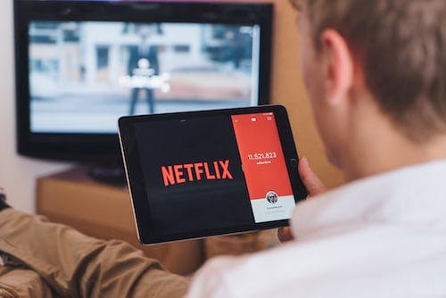 Man using an tablet to watch Netflix