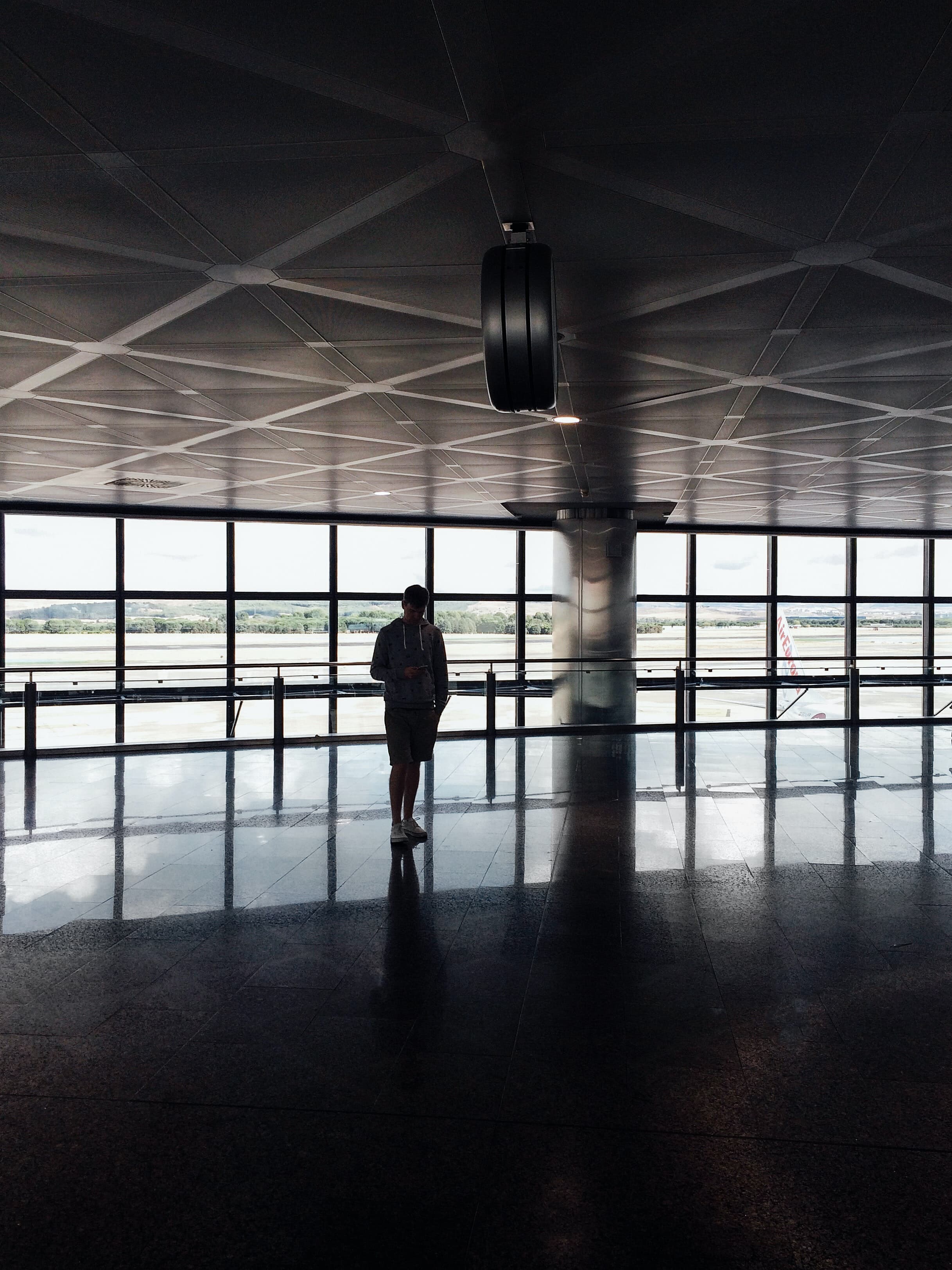 a man walks through the airport terminal.