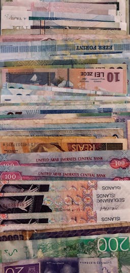 a collection of banknotes from various countries.
